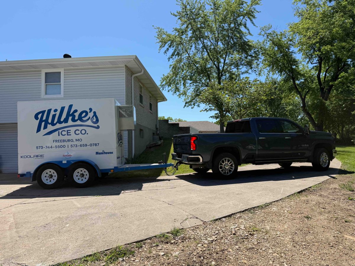 Hilke's new white and blue event ice trailer being towed